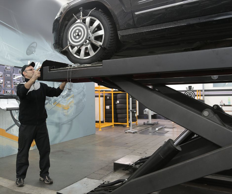 person working on a lifted car