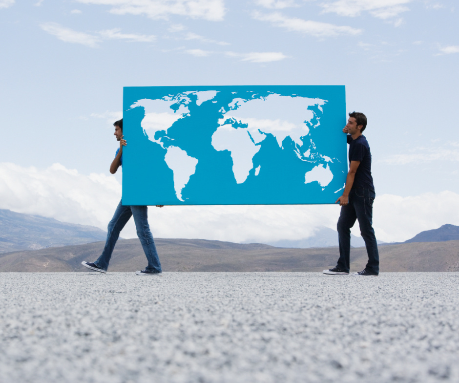 two people holding world map painted on glass