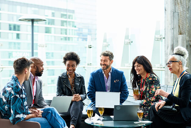 A group of people sitting together and discussing a project.