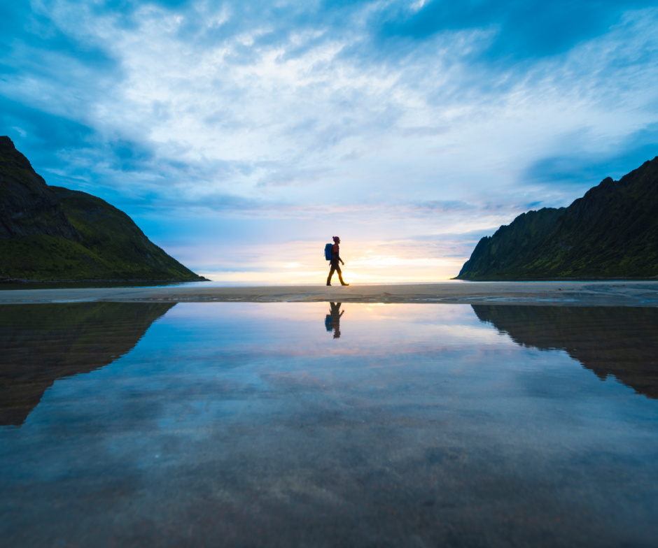 person walking along a large body of water