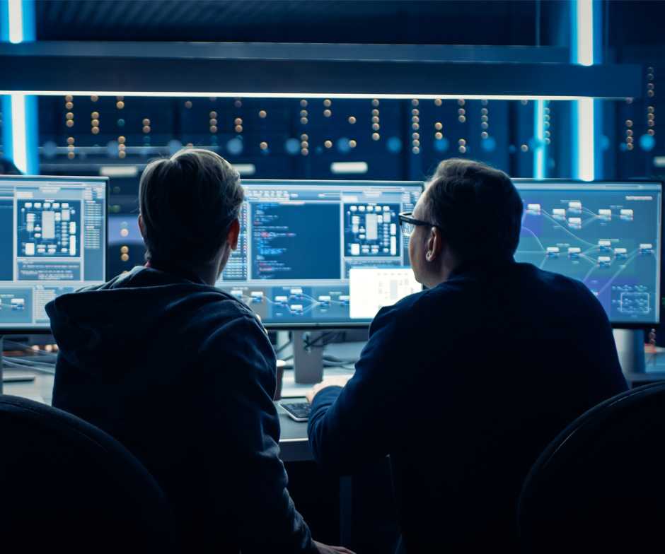 two people looking at monitors