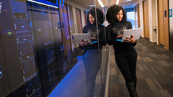 a person holding laptop in a datacenter